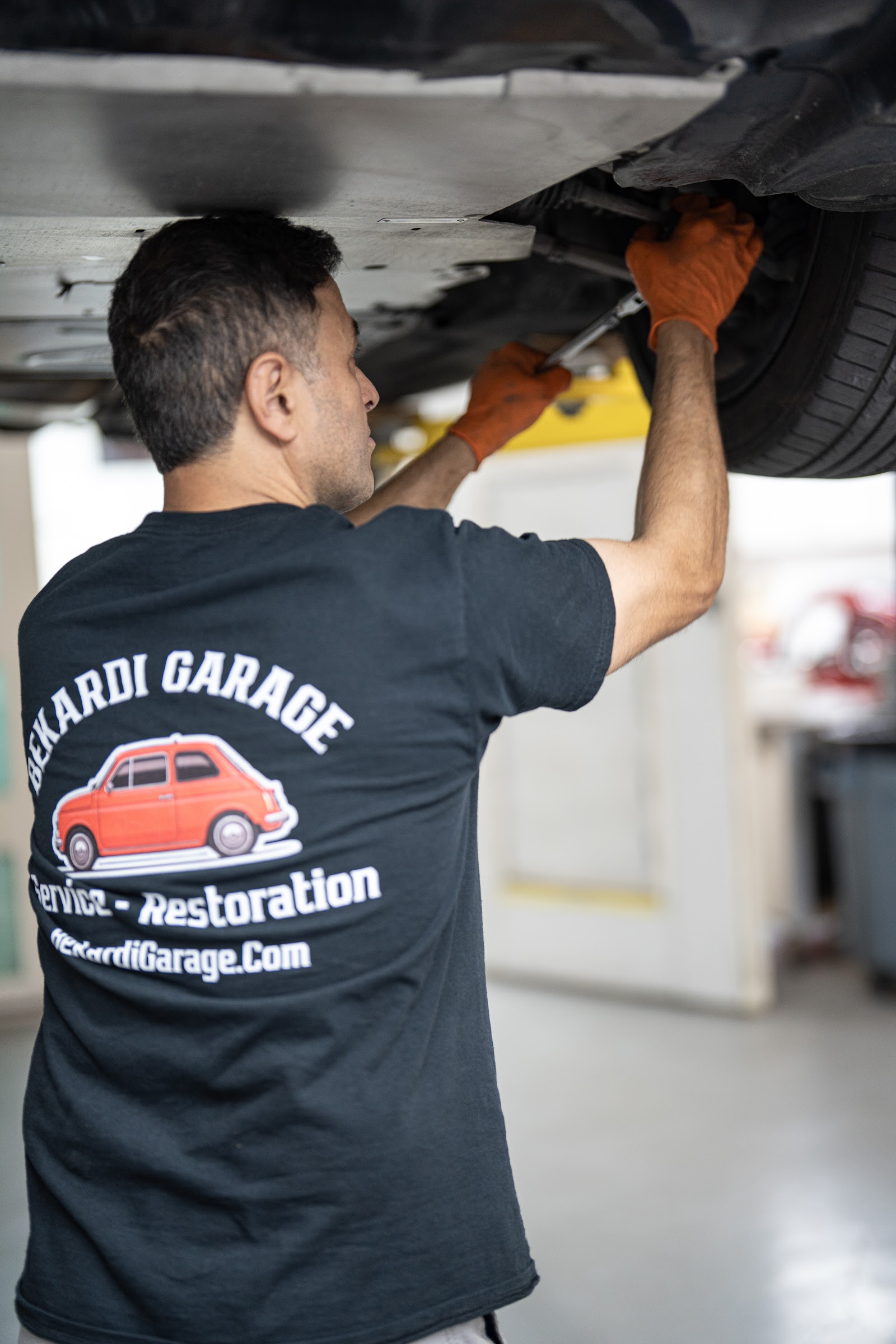 Bekardi Garage technician inspecting a car underbody in Houston