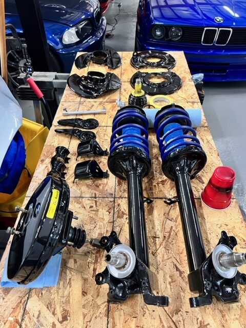 BMW suspension components prepared for installation at Bekardi Garage Houston