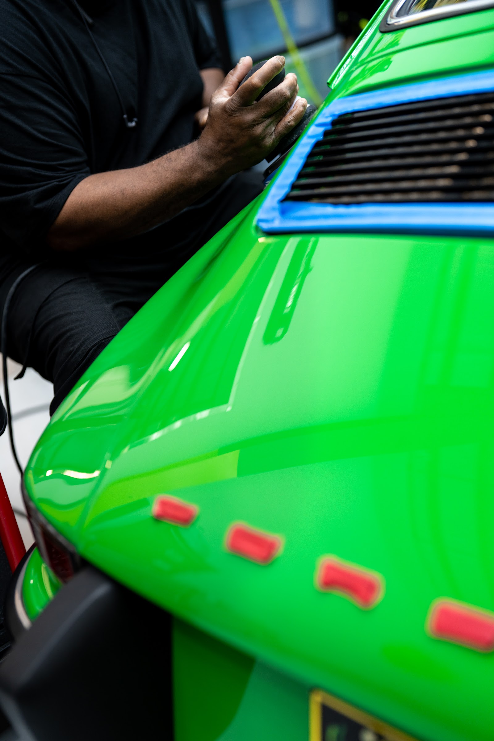Bekardi Garage technician working on a green European car in Houston